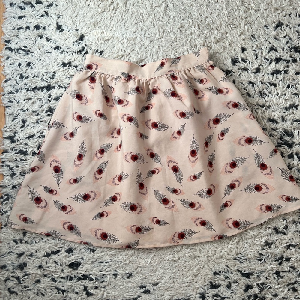 Elegant Cream Skirt with Peacock Feather Design